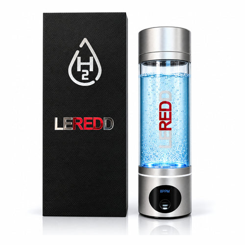 A LEREDD H2 water hydrogen bottle with a clear chamber filled with blue bubbles, shown next to its black textured packaging box on a white background.