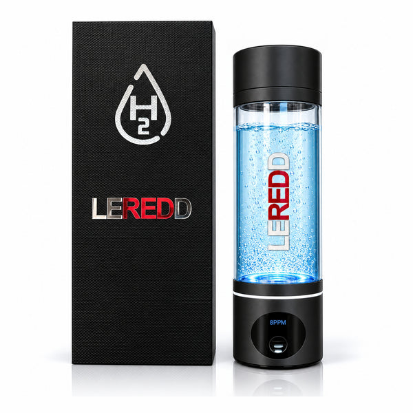 A LEREDD H2 water hydrogen bottle  with black accent  colour on lid and base with a clear chamber filled with blue bubbles, shown next to its black textured packaging box on a white background.