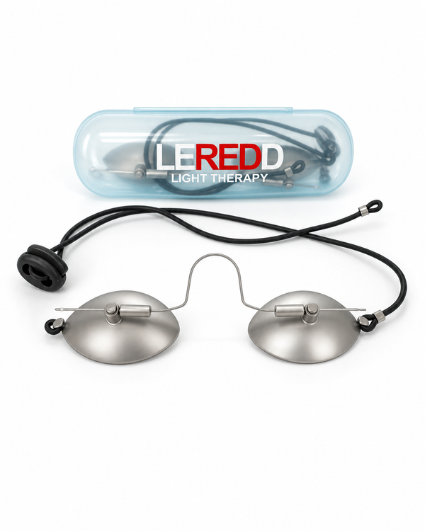 A pair of LEREDD Light Therapy IPL Steel goggles with oval silver metal lenses, a black adjustable elastic round strap, and a clear plastic carrying case with the LEREDD brand logo, shown on a white background.