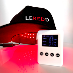 Red light therapy Brain treatment and Hair growth Cap with remote control device on a white background, featuring the brand 'LEREDD'
